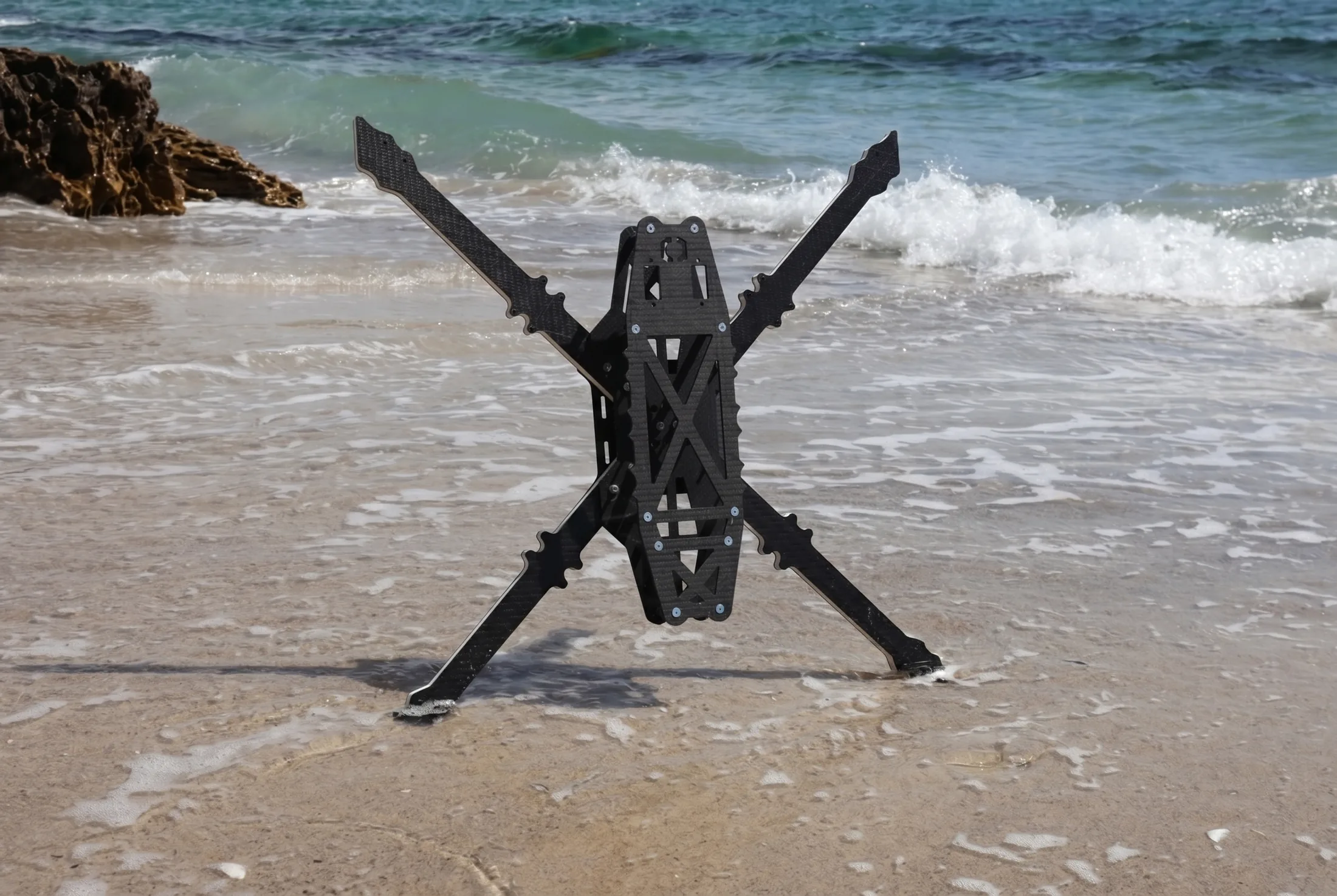 Frontline NextGen carbon composite airframe in surf at the shoreline